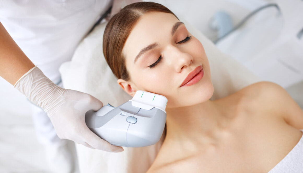 Woman getting facial lifting therapy in beauty salon