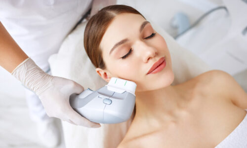 Woman getting facial lifting therapy in beauty salon
